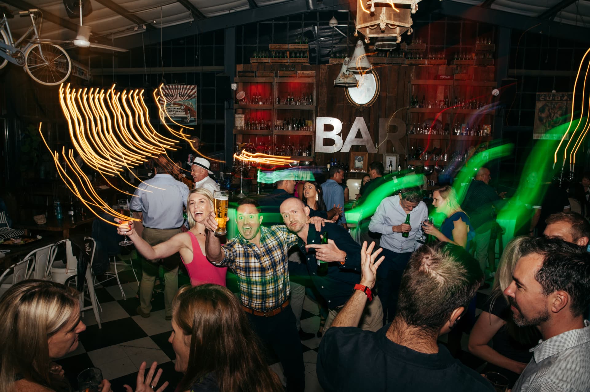 Guests raising glasses and cheering at a party