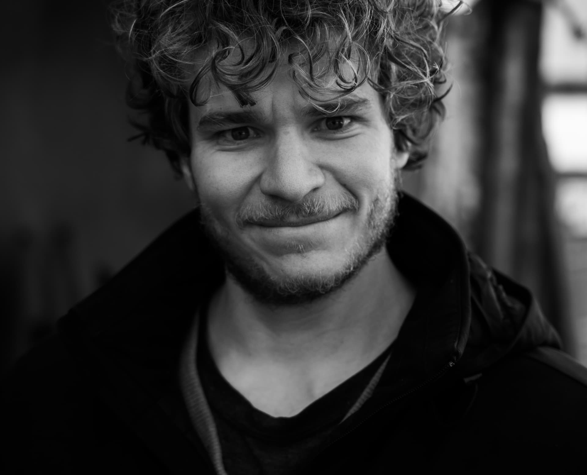 Black and white portrait of Chris Doman smiling