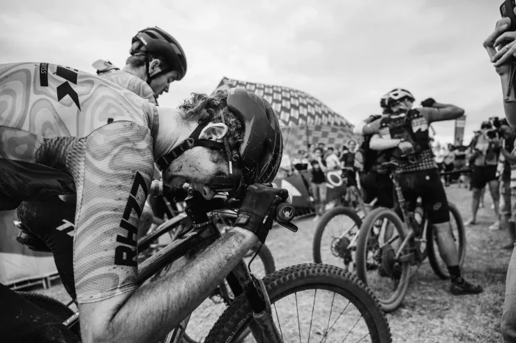 Black and white mountain biker exhausted at the finish